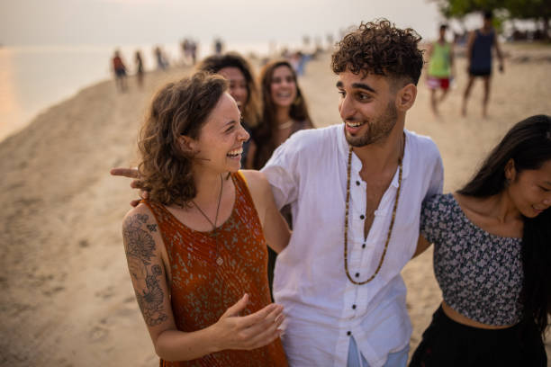 istock Multiracial friends embraced walking on the beach during sunset 1405387744