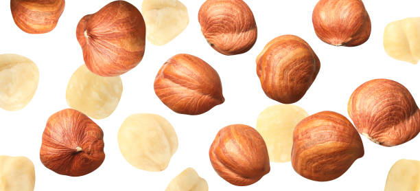 istock Tasty hazelnuts falling on white background, banner design. Healthy snack 1405387846