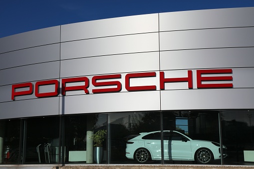 Porsche car brand dealership in Essen, Germany. There were 45.8 million cars registered in Germany (as of 2017).