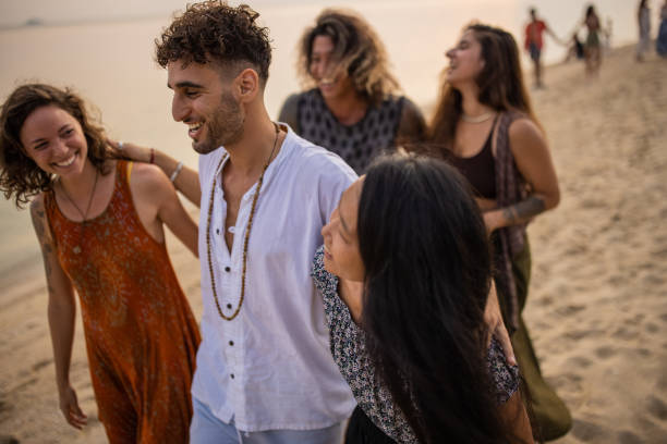 istock Urban multiracial friends walking on the beach during sunset 1405388461