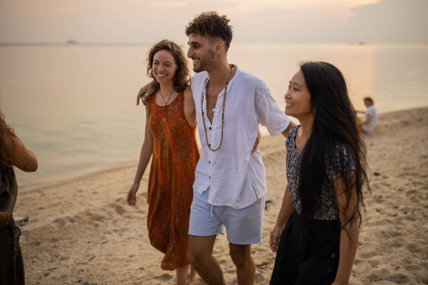 istock Serene multiracial friends walking on the beach during sunset 1405389172