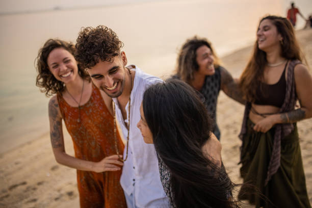 istock Urban multiracial friends walking on the beach during sunset 1405389976