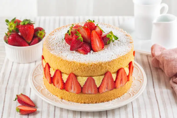 Photo of Homemade French Fraisier Cake made with two layer of Genoise Sponge, Diplomat Cream and Fresh Strawberries. Delicious Summer Cake packed with fresh berries.