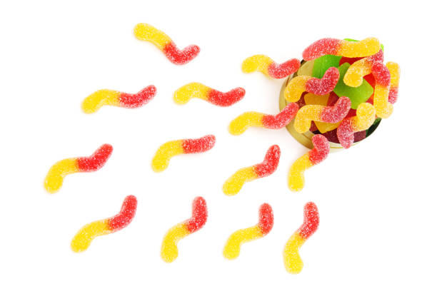 istock Gummy worm candies scattered on white background 1405390300