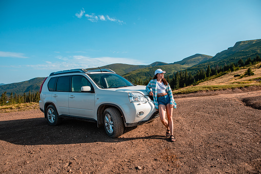 suv car on the top of ukraine carpathian mountain range summertime evening