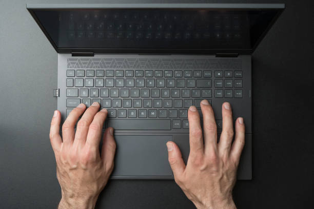 istock Laptop computer keyboard with user or gamer hands on black stylish background. Technology, business, internet concept. 1405391602