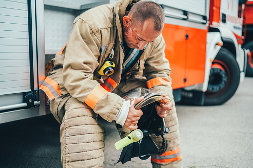 Unhappy firefighter sitting at the fire engine