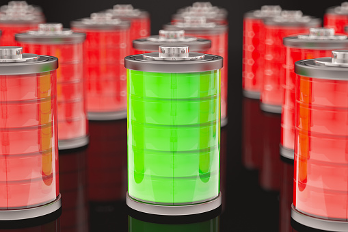 Green Full Battery Among Red Batteries. 3D Render