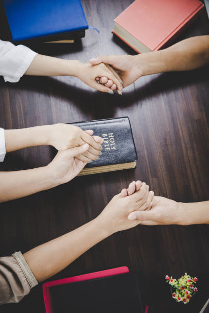 istock Group of people praying worship believe 1405392924