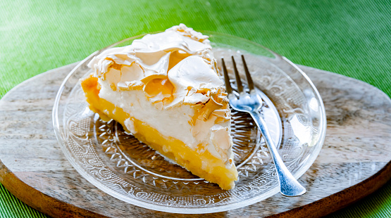 A plate with a lemon meringue tart.