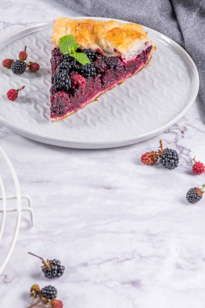 istock Sliced blackberries pie. Pie in summer with fresh picked wild blackberries. 1405394181