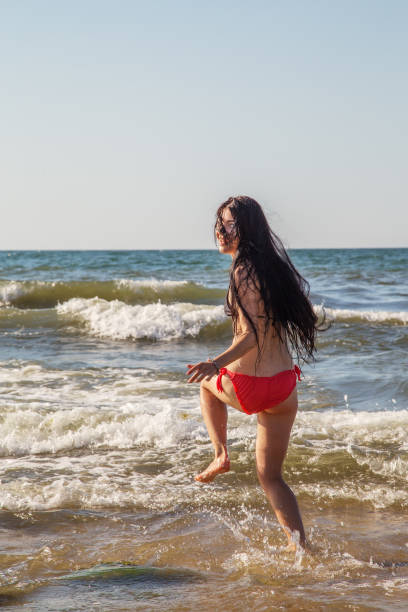 istock girl jumping in sea 1405394189