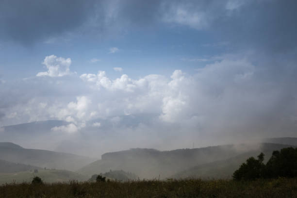 istock Cumulus clouds over the mountains 1405394557