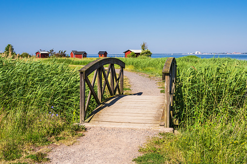 Bridge and Fishing huts on shore of the Baltic Sea on the island Öland in Sweden.