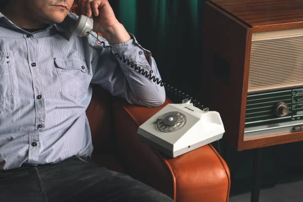 istock Special secret agent speaking by old landline phone. Spying or intelligence gathering. Espionage concept. Report information to superiors. 1405395964