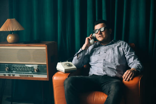 istock Special secret agent speaking by old landline phone. Spying or intelligence gathering. Espionage concept. Report information to superiors. 1405395989