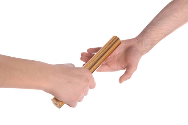 istock Man passing relay baton to teammate isolated on white, closeup 1405396405