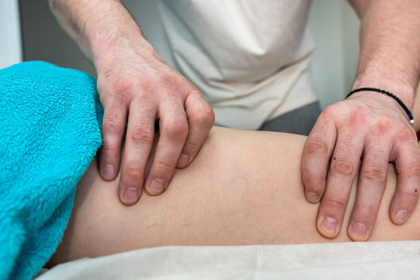 istock physio therapist doing healing massage on female leg 1405397103