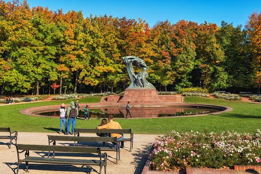 Warsaw, Poland - October 8, 2021: Royal Lazienki Park in autumn with Frederic Chopin Monument by the pond.