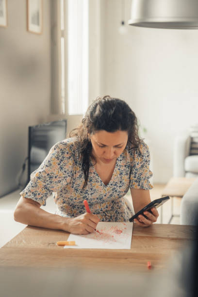 istock Woman using smartphone at home 1405397647