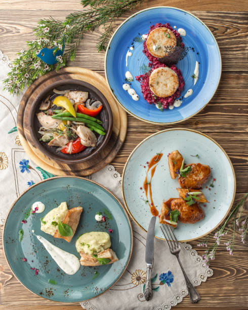 istock Set of various chicken and fish dishes main course on wooden table 1405398684