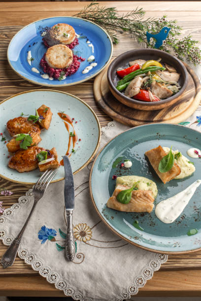 istock Set of various chicken and fish dishes main course on wooden table 1405398703
