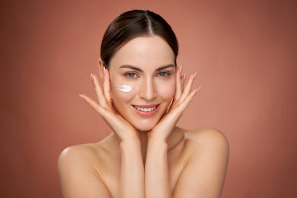 istock Woman with cosmetic product on face 1405398753