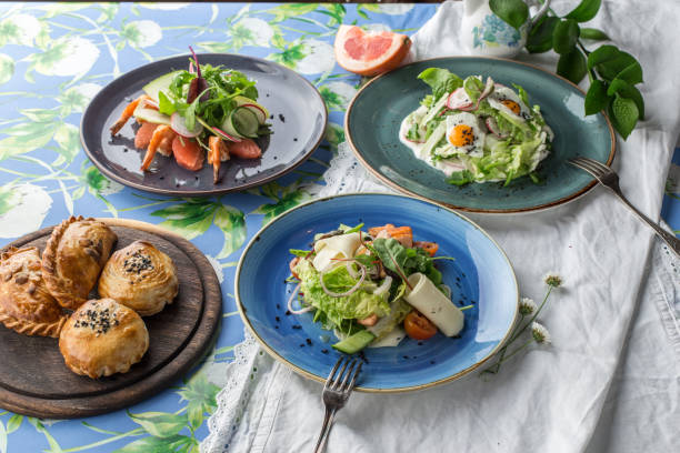 three different salads and bread bun for the menu on the table side view