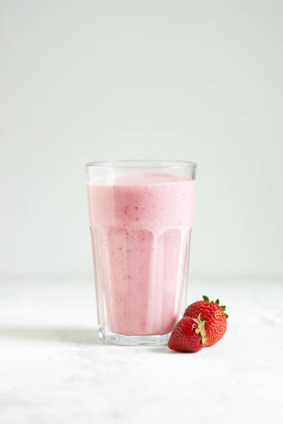 istock Strawberry smoothie pouring in glass. 1405401216