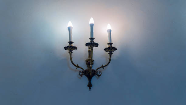 istock Vintage wall lamp. Space for text. Lamp light on the wall. Working lamps at dusk. 1405403431