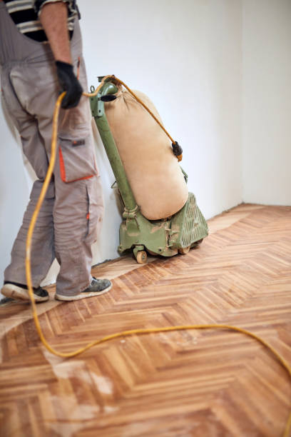 istock Repairman restoring parquet with a sanding machine. 1405404224