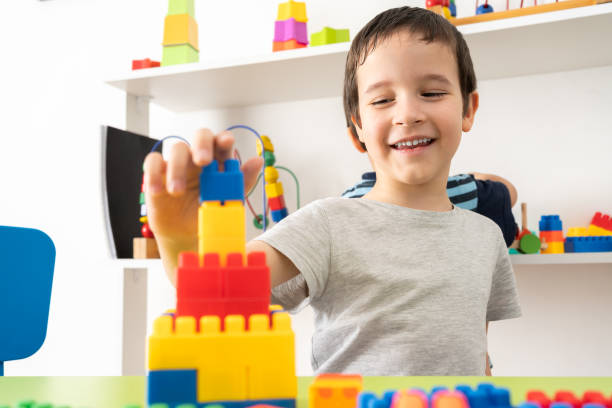 istock Little boy playing with colourful educational toy blocks 1405404857
