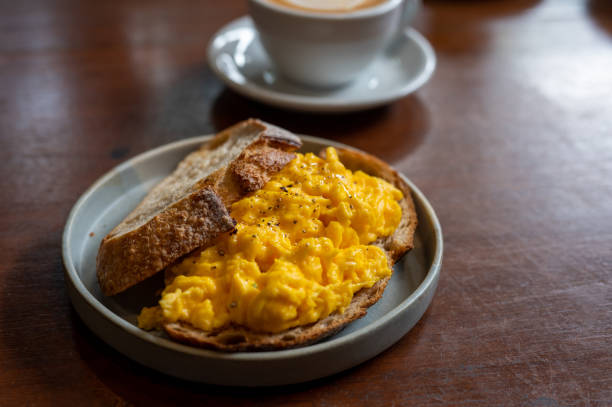 istock Light, Fluffy and Buttery Scrambled Eggs on Toast with a cup of coffee 1405405143