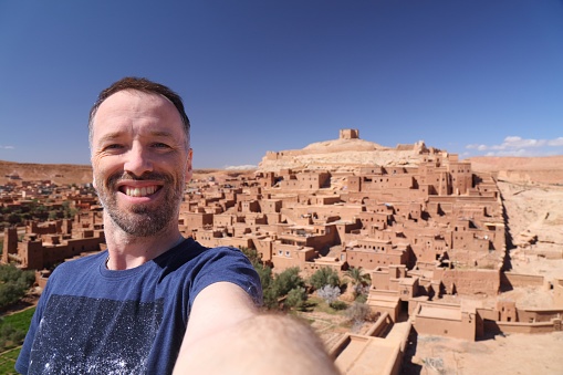Tourist selfie in Ait Benhaddou, Morocco. Historic ksar town on a caravan route.