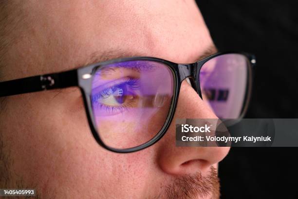 Man In The Glasses Watches To The Monitor Reflection In The Googles Stock Photo - Download Image Now