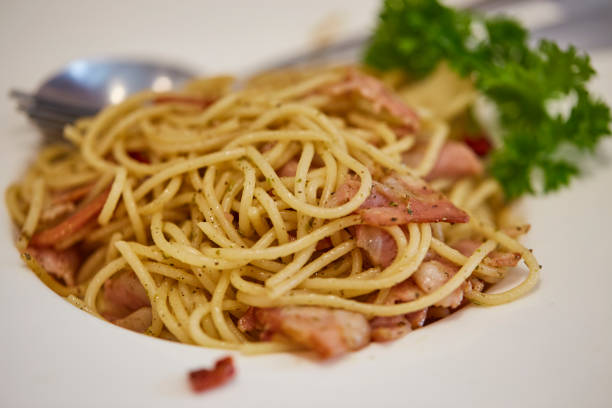 Selective focus of spaghetti with chili and bacon, spaghetti fusion style