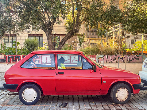 Valencia, Spain - June 24, 2022: Red Ford car second generation model Fiesta parked in the street. The American manufacturer produced it from 1983 to 1989
