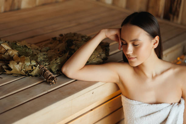 istock Young woman relaxing in sauna 1405411816