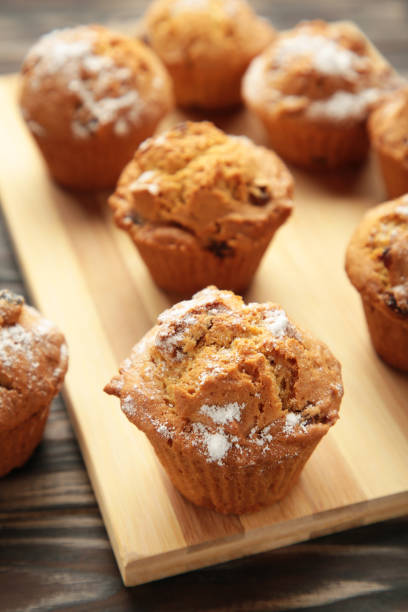 istock Vanilla muffins. Sweet cupcakes on cutting board. Top view. 1405412663