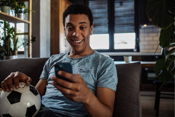istock Soccer fan using mobile app for betting 1405413810