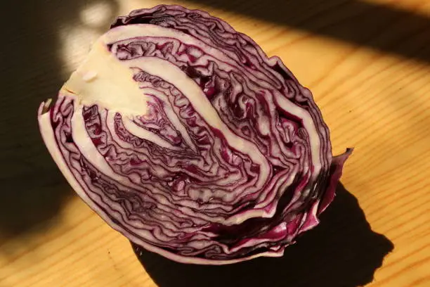 Inside pattern of half red cabbage on wooden table