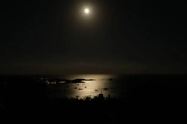 Full moon reflection on ocean on Cadaques Bay in Spain