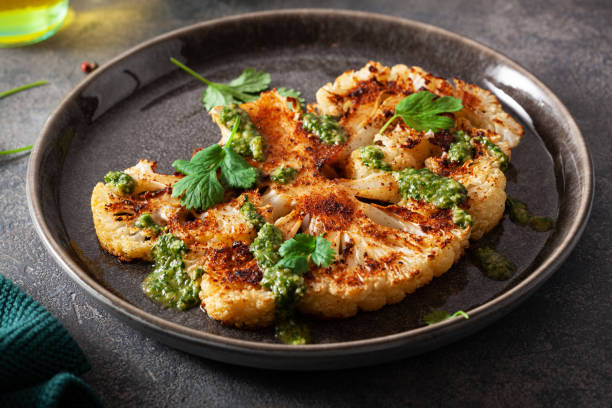istock cauliflower steaks with herb sauce and spice. plant based meat substitute 1405415366