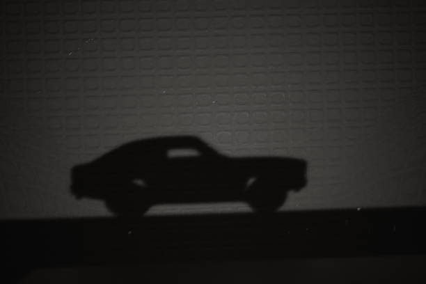 Toy red car on black background with copy space