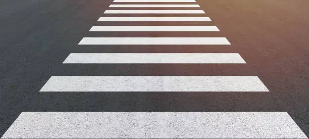 Photo of Crosswalk on the road for safety when people cross the road, crossing on a repaired asphalt road