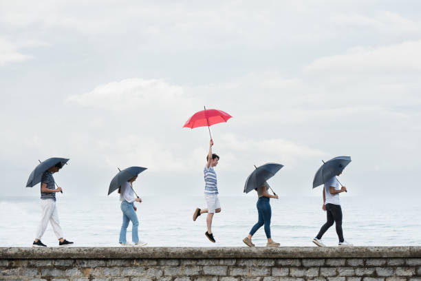 istock Joyful teenager boy standing out from crowd 1405419934