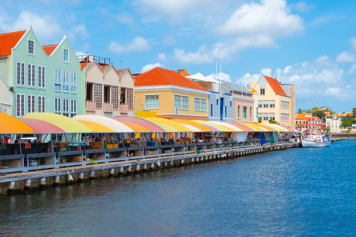 Colorful buildings with local market at the waterfront. Popular place for tourists. It used to be a floating fish market. Curacao, Netherlands Antilles, Leeward Islands, Caribbean.