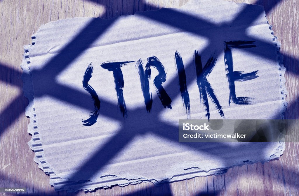 Banner with strike word Handwritten word strike on cardboard  ,protest and sadness Strike - Protest Action Stock Photo