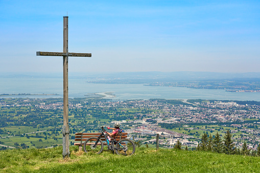 nice senior woman riding her electric mountain bike  in the Bregenzer Wald mountain range above Bregenz and Lake of Constance in Vorarlberg, Austria