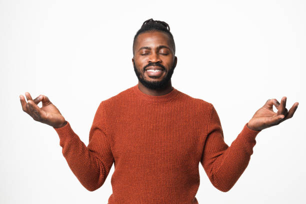 istock Relaxed serene resting african-american young man with dreadlocks and eyes closed meditating, feeling zen-like isolated in white background 1405420824